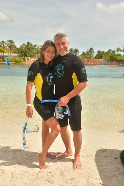 Veronica and Armando together in diving gear on a tropical beach