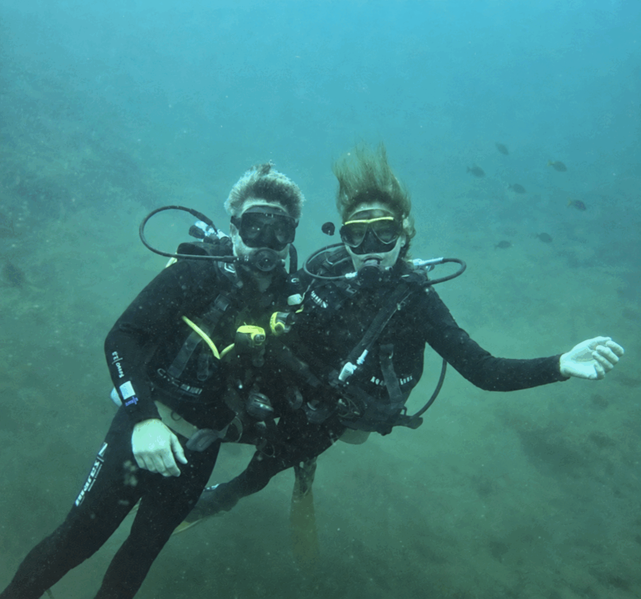 Veronica and Armando scuba diving together underwater